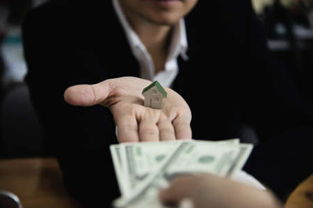 Business man show money bank note make financial plan invite people to sell or buy house and car -...