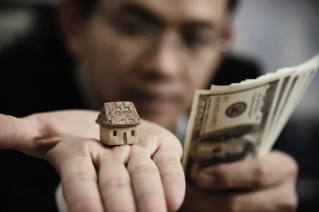 Business man show money bank note make financial plan invite people to sell or buy house and car - monetary properties loan credit insurance conceptの写真素材