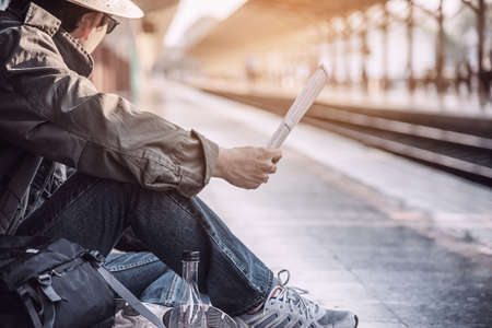 Travel man wait train at platform - people vacation lifestyle activities at train station transportation conceptの写真素材