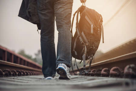 Travel man wait train at platform - people vacation lifestyle activities at train station...