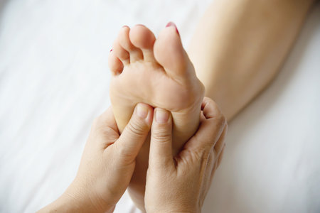 Woman receiving foot massage service from masseuse close up at hand and foot - relax in foot massage therapy service conceptの写真素材