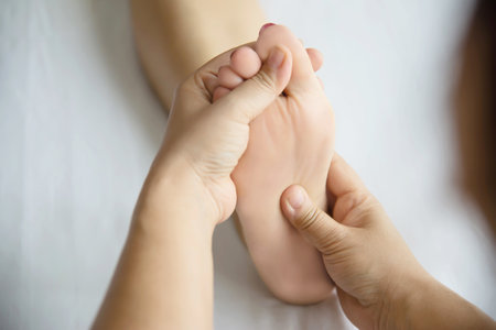 Woman receiving foot massage service from masseuse close up at hand and foot - relax in foot massage therapy service conceptの写真素材