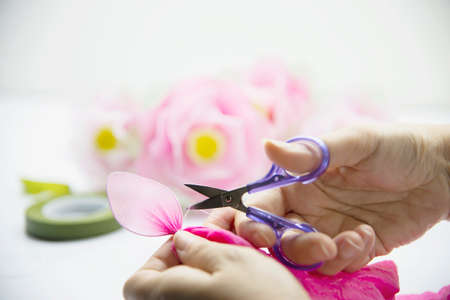 Woman making beautiful nylon flower - people with DIY handmade flower concept