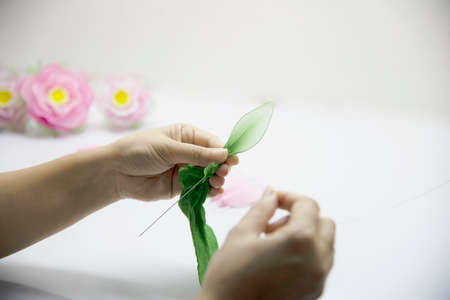 Woman making beautiful nylon flower - people with DIY handmade flower conceptの写真素材