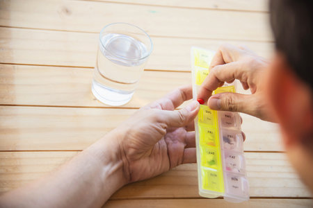 Man is going to eat medicine tablet - people with medical health problem conceptの写真素材