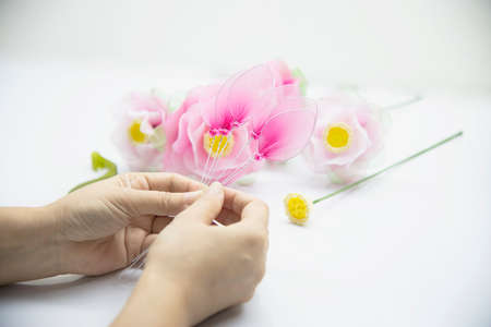 Woman making beautiful nylon flower - people with DIY handmade flower conceptの写真素材