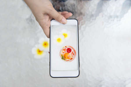 Lady taking photo of cocktail recipe name mai tai or mai thai worldwide favour cocktail - sweet alcohol drink with people enjoy relax vacation conceptの写真素材