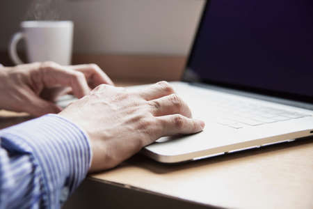 Businessman working with computer with coffee cup in the hotel room - people working lifestyle conceptの写真素材