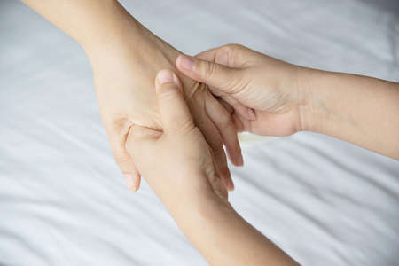 Hand spa massage over clean white bed background - people relax with hand massage serviceの写真素材