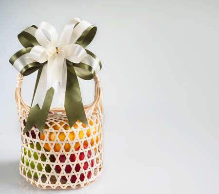 Fresh fruit souvenir in weaved bamboo package over white gray background - fresh fruit gift set for...