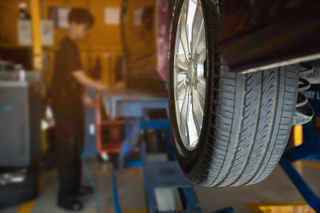 Technician is inflate car tire - car maintenance service transportation safety conceptの写真素材