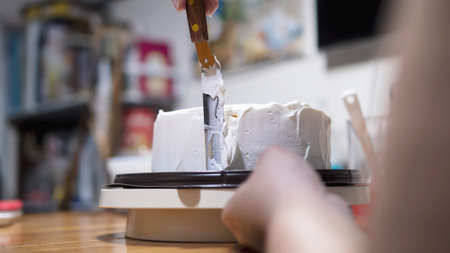 Lady making cream cake - people with homemade bakery concept