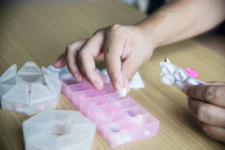 Woman prepare to eat periodical daily medicine pill - people healthcare with medicine pills conceptの写真素材