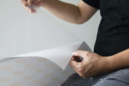 Man installing sticker film to mirror window house interior decoration