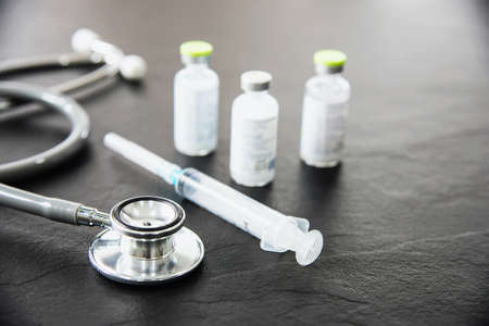 Stethoscope and syringe with Covid-19 vaccine setの写真素材