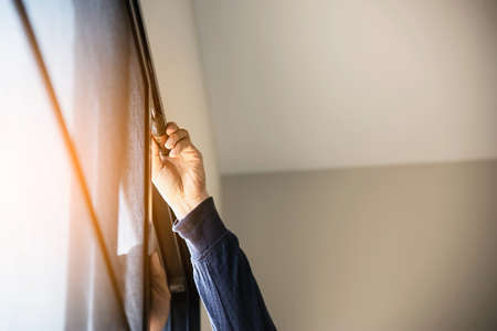 Man doing aluminum frame with wire screen door and window installation work in construction site