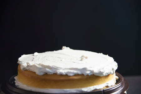 Homemade cake preparation over black background - bakery cooking conceptの写真素材