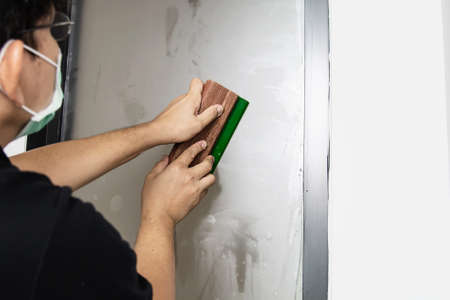 People installing sticker film to mirror window house interior decorationの写真素材