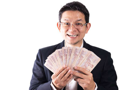 Thai business man happy holding Thai baht note money - people with business success conceptの写真素材