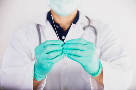 Doctor showing rapid antigen test Covid -19 self repid test set