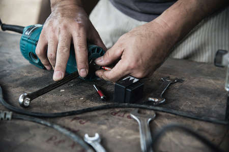 Man preparing electric router laminate trimmer machine tool - carpenter workshop conceptの写真素材
