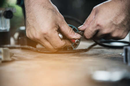 Man preparing electric router laminate trimmer machine tool - carpenter workshop concept