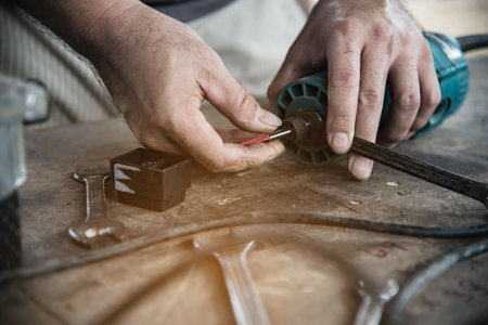 Man preparing electric router laminate trimmer machine tool - carpenter workshop concept