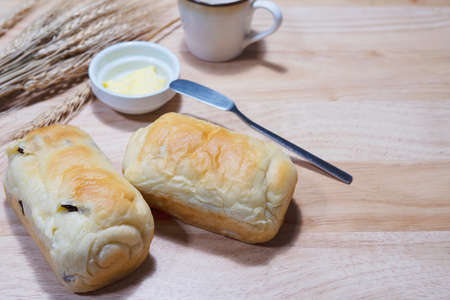 Holewheat toast with dry wheat and butter on wooden table - bakery breakfast background concept
