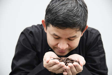 Thai barista is testing rosted coffee bean smell prepare to make coffee cup