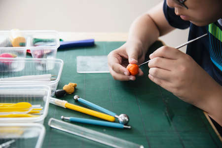 Boy is playing polymer clayの写真素材