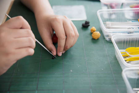 Boy is playing polymer clayの写真素材
