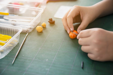Boy is playing polymer clayの写真素材