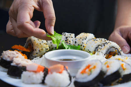 japanese sushi roll serving in oriental restaurant, chef is preparing japan tradition cookery menu, various different assorted luxury mixed healthy eating set conceptの写真素材