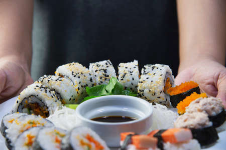 japanese sushi roll serving in oriental restaurant, chef is preparing japan tradition cookery menu, various different assorted luxury mixed healthy eating set conceptの写真素材