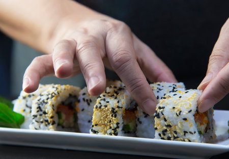 japanese sushi roll serving in oriental restaurant, chef is preparing japan tradition cookery menu, various different assorted luxury mixed healthy eating set conceptの写真素材