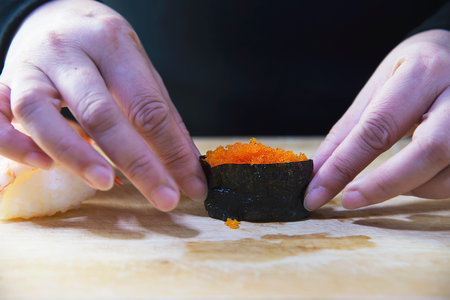 japanese maki sushi roll serving in oriental restaurant, chef is preparing japan tradition cookery menu, various different assorted luxury mixed healthy eating set conceptの写真素材