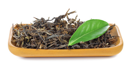 black tea with leaf isolated in wooden on white backgroundの写真素材