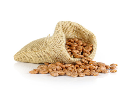 Pinto-beans isolated in sack on white backgroundの写真素材