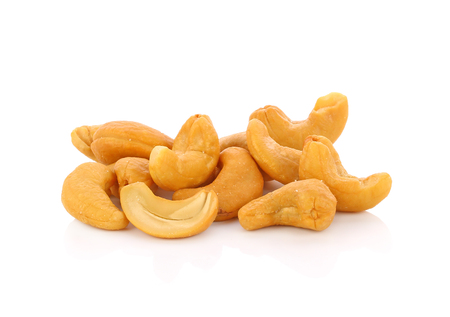 Roasted cashew nuts whith salt on white backgroundの写真素材