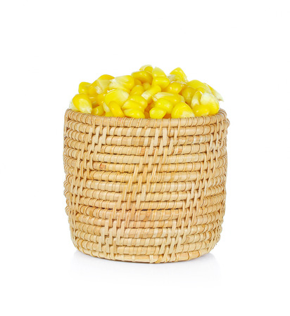 Sweet whole kernel corn in basket on white backgroundの写真素材