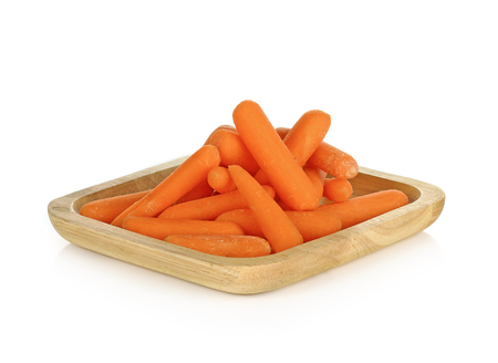 babay carrots in wooden plate on white backgroundの写真素材