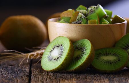 sliced kiwi fruit on wooden backgroundの写真素材