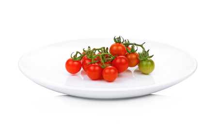 Wild tomato in white plate isolate on white backgroundの写真素材