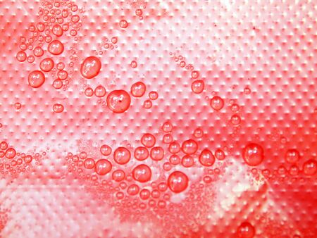 Water drops on a red backgroundの写真素材