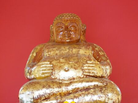 Buddha statue with a red backgroundの写真素材