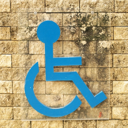 disabled person sign on brick wallの写真素材