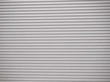 Illuminated grunge metallic roller shutter doorの写真素材