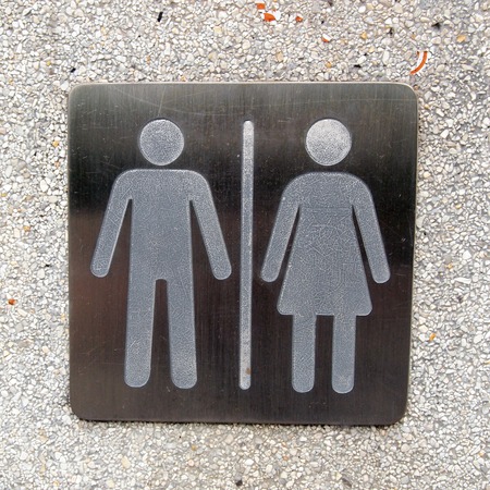 toilet plate sign on wall 