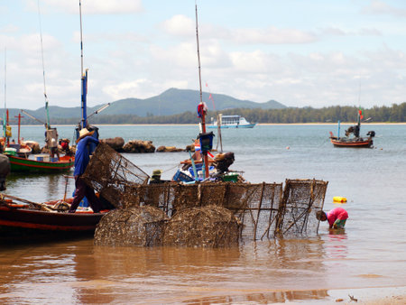 CHUMPHON THAILAND SEPTEMBER 22: Fisherman carrys net in his boat on 22 september 2012 in Chumphon Thailand.のeditorial素材