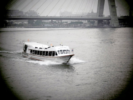 BANGKOK, THAILAND - JANUARY 3 : typical long tail boat down Chao Praya river in Bangkok on 3 January 2012. The river is a major transportation artery for a vast network of water buses and taxis のeditorial素材